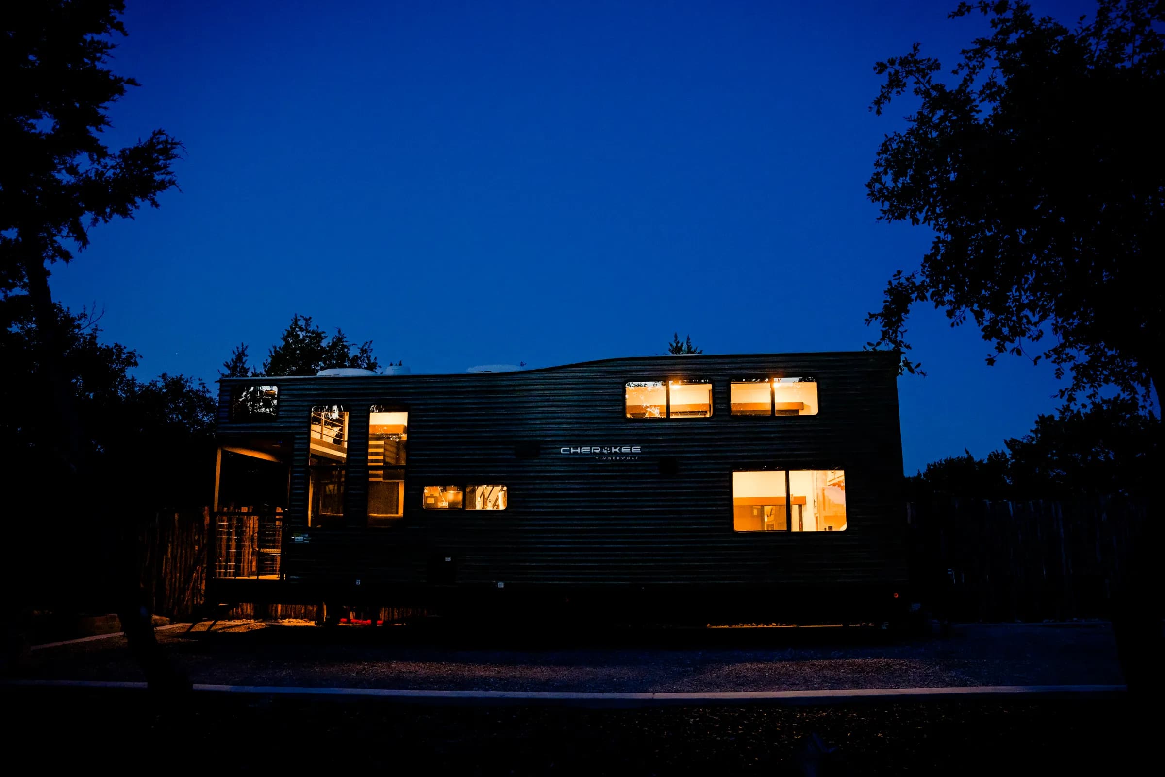 Blancobreeze Cherokee Timberwolf glamping RV lit up at blue hour