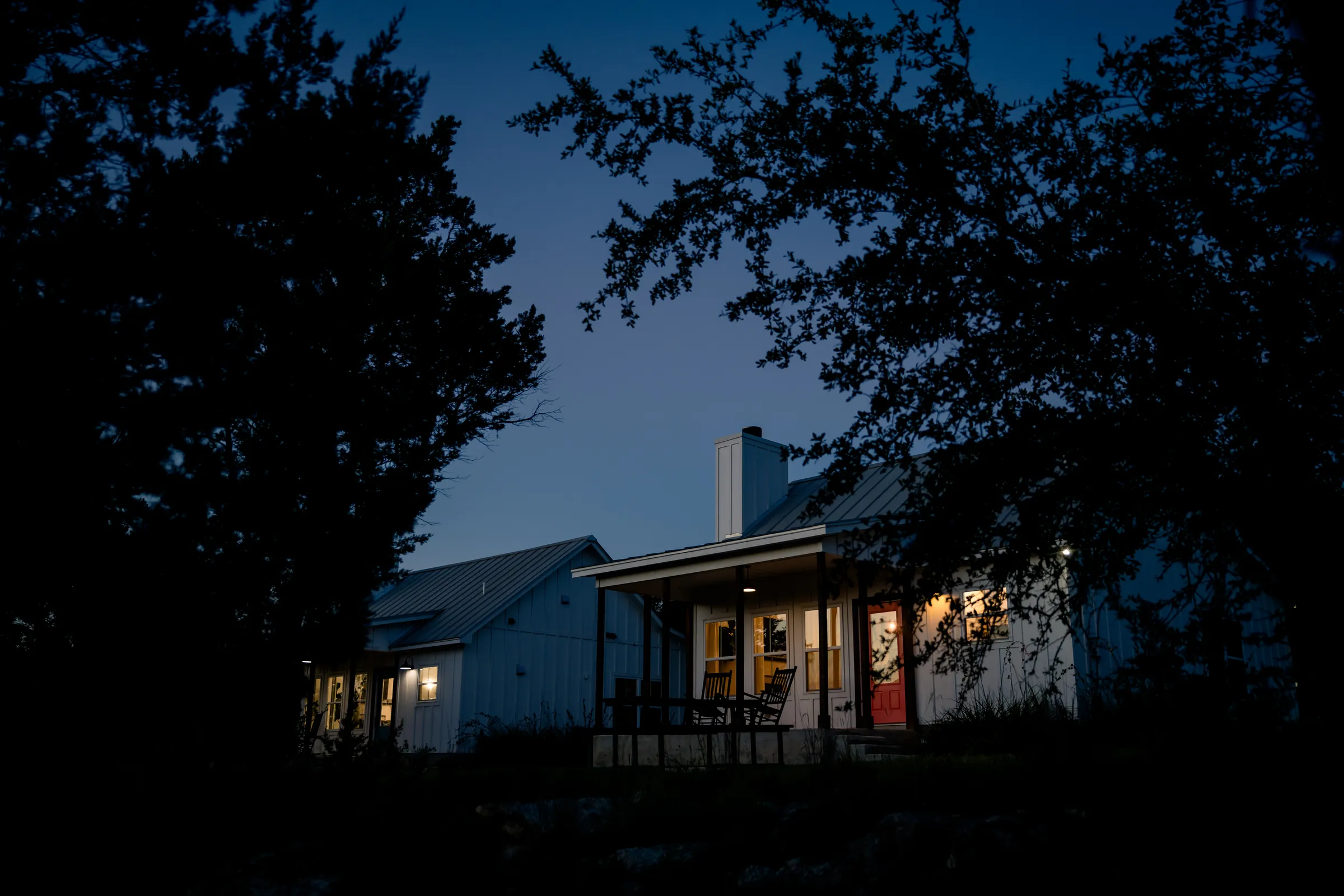 Summermoon Cottage glowing at twilight under the Hill Country sky