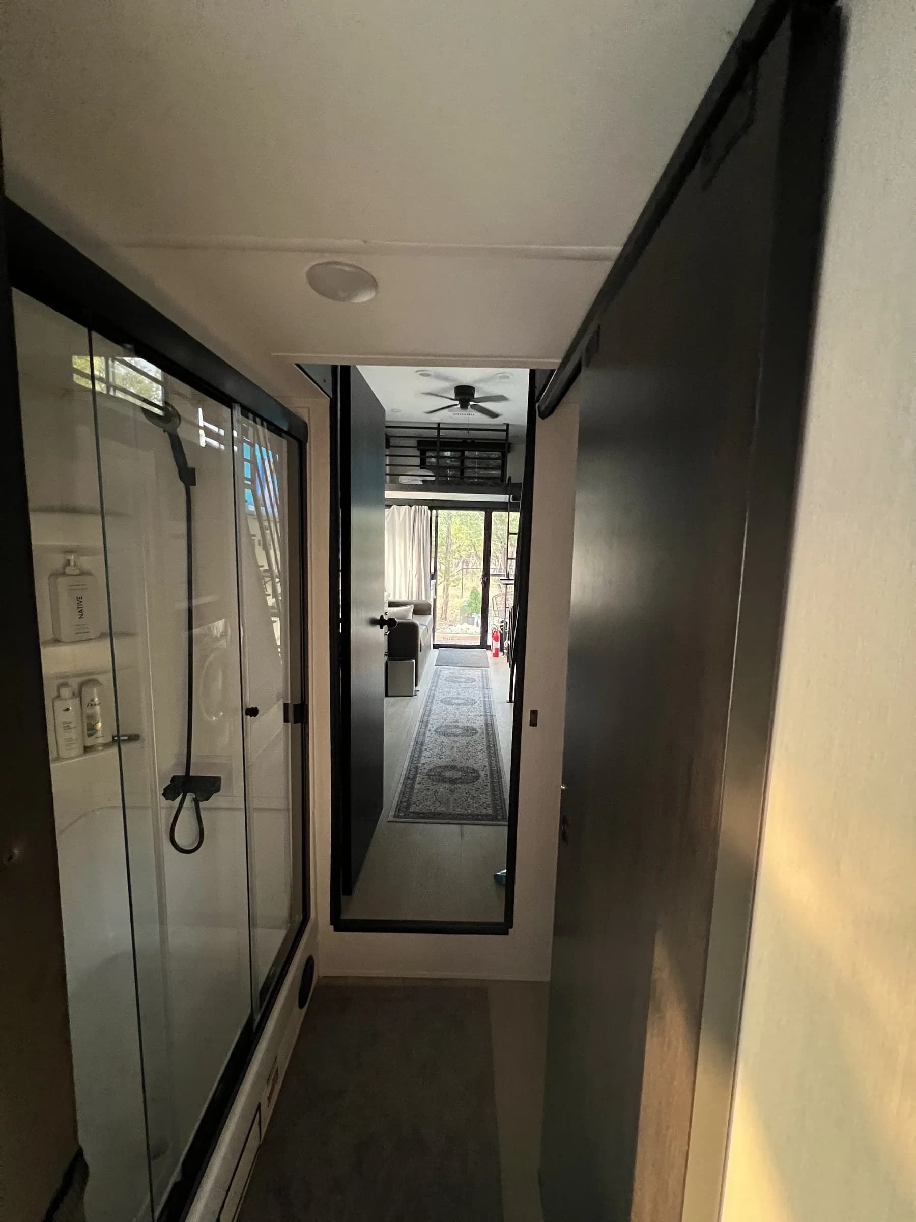 Hallway leading to the tiled shower inside Blancobreeze