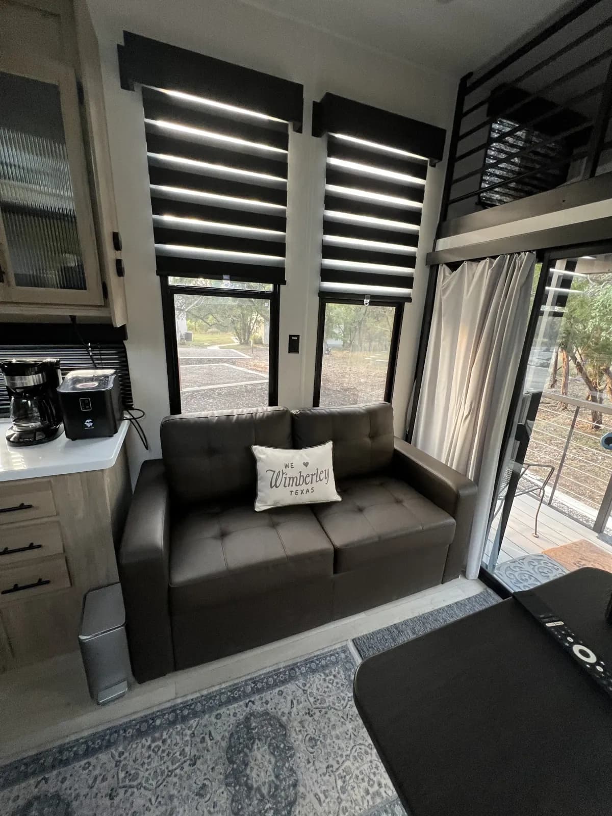 Loveseat and coffee station inside Blancobreeze glamping RV