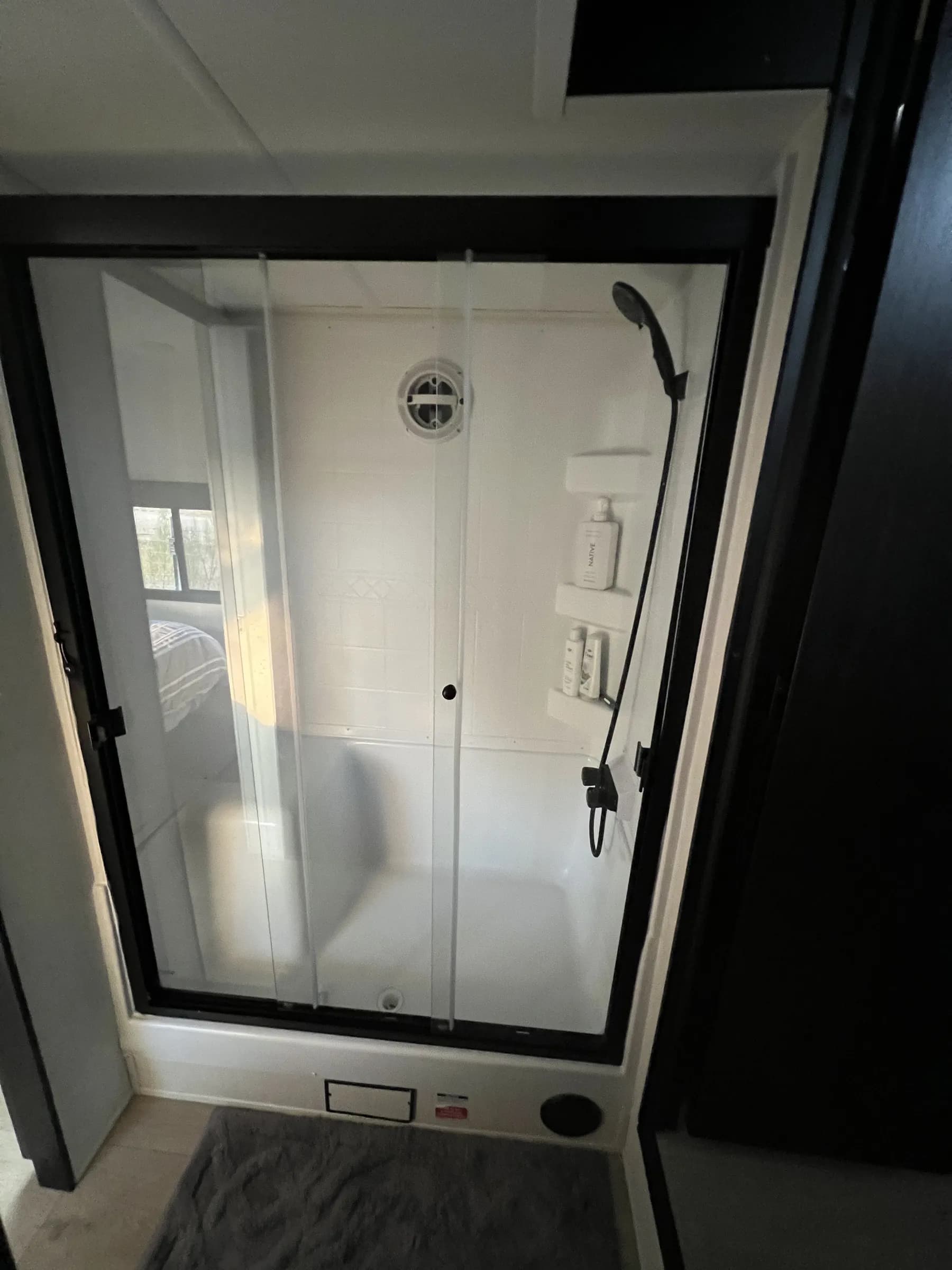Glass shower stall inside Blancobreeze glamping RV