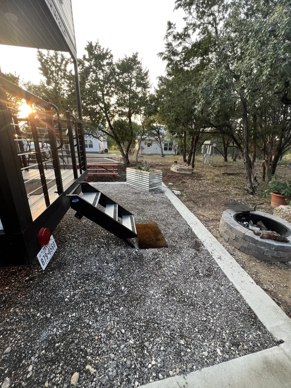 Fire pit and gravel site beside Blancobreeze at sunset
