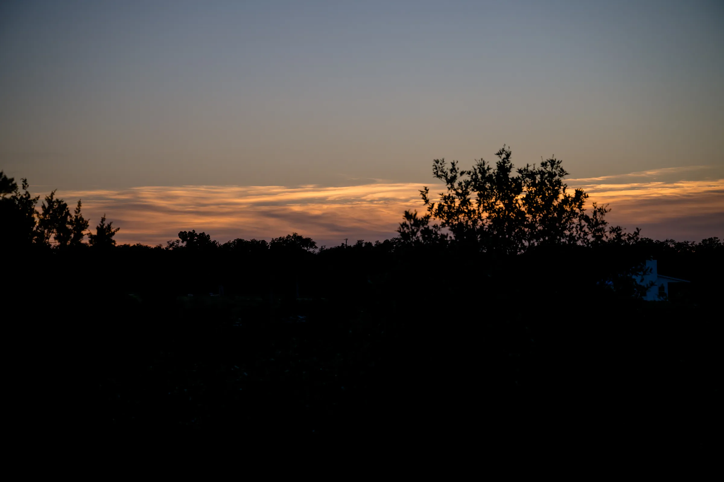 Golden sunset over the Hill Country treeline at Wayside Wimberley