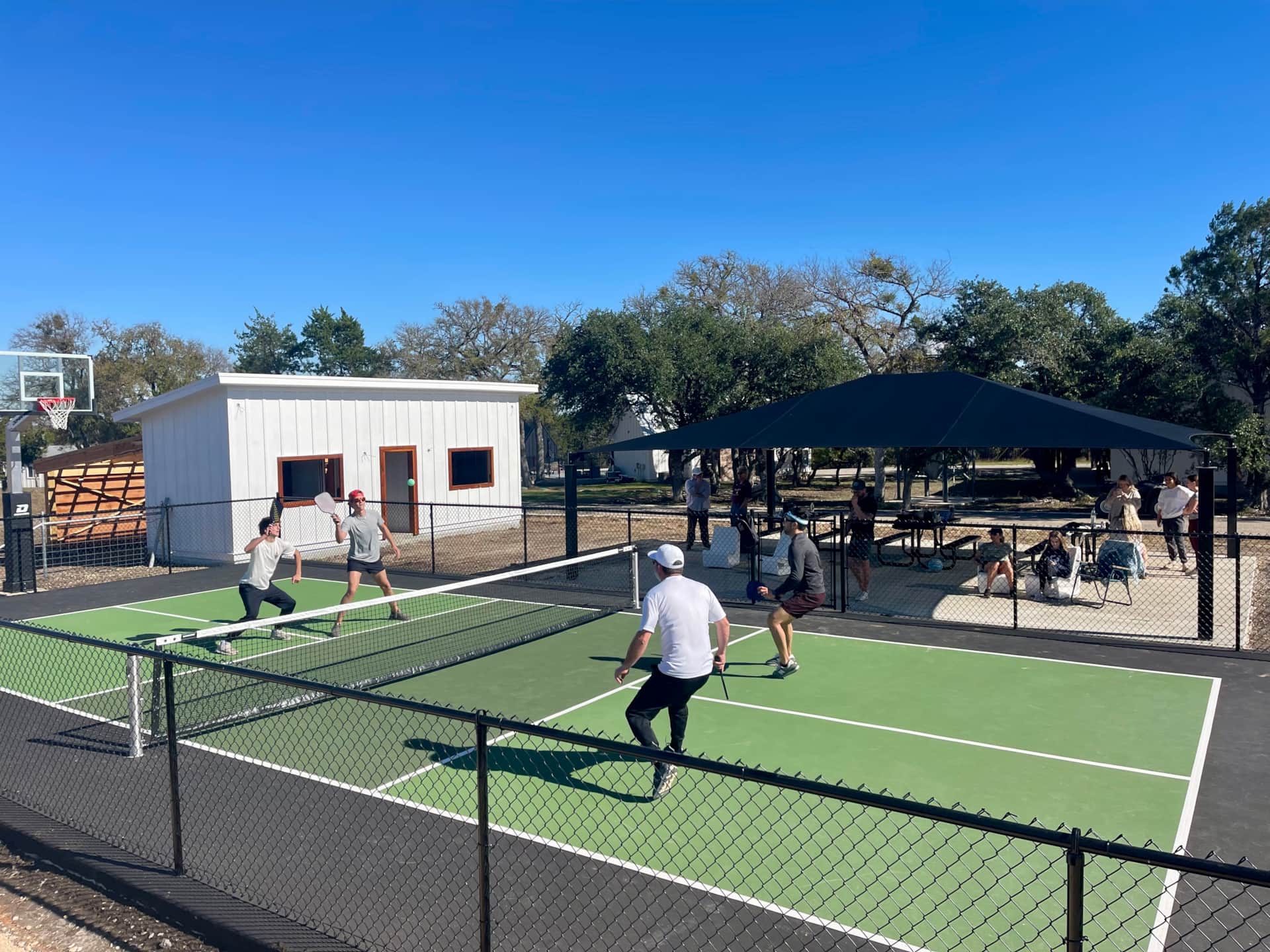 Pickleball court at Wayside Wimberley with clubhouse in background