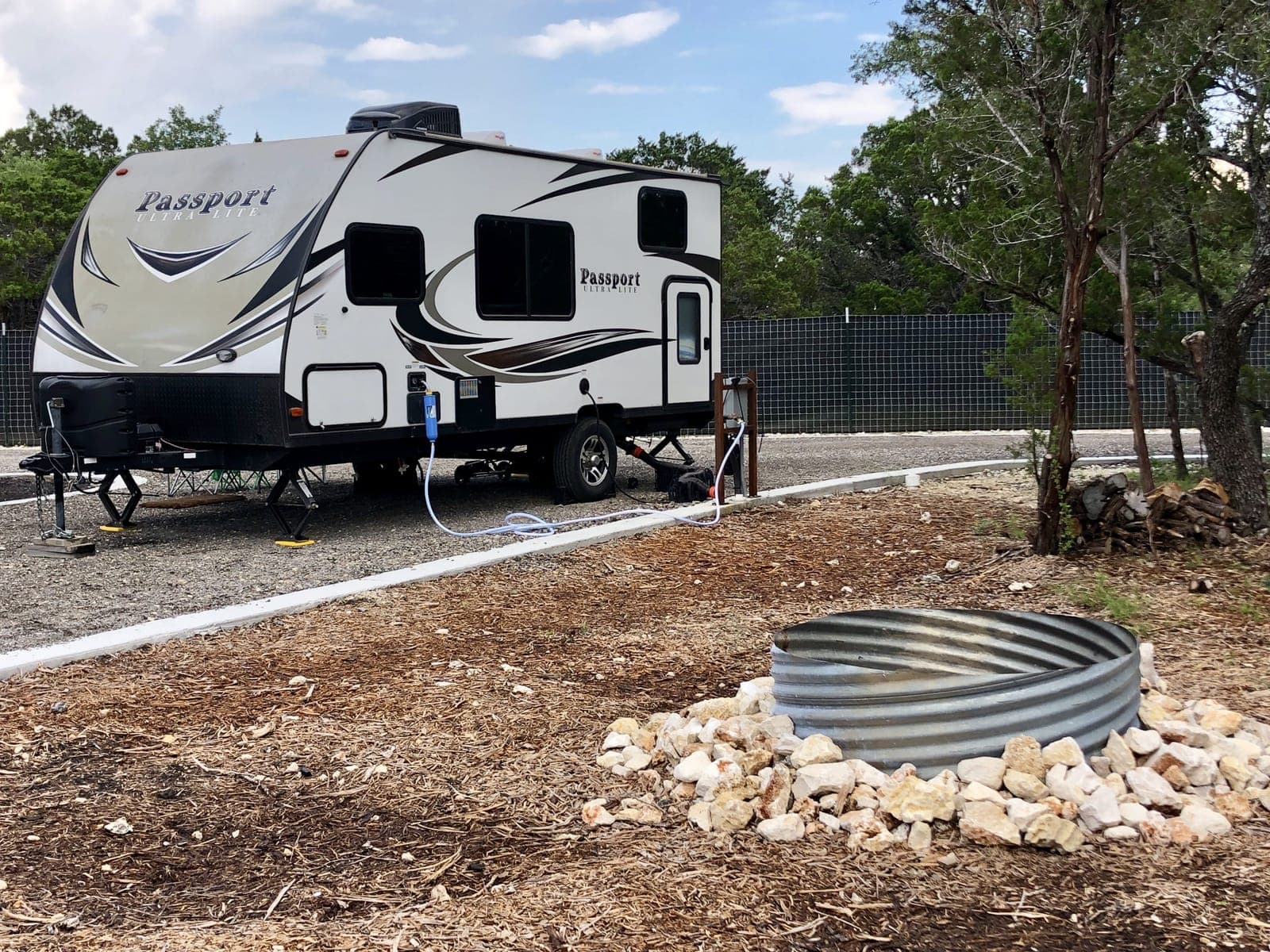 RV site with fire pit and landscaping at Wayside Wimberley