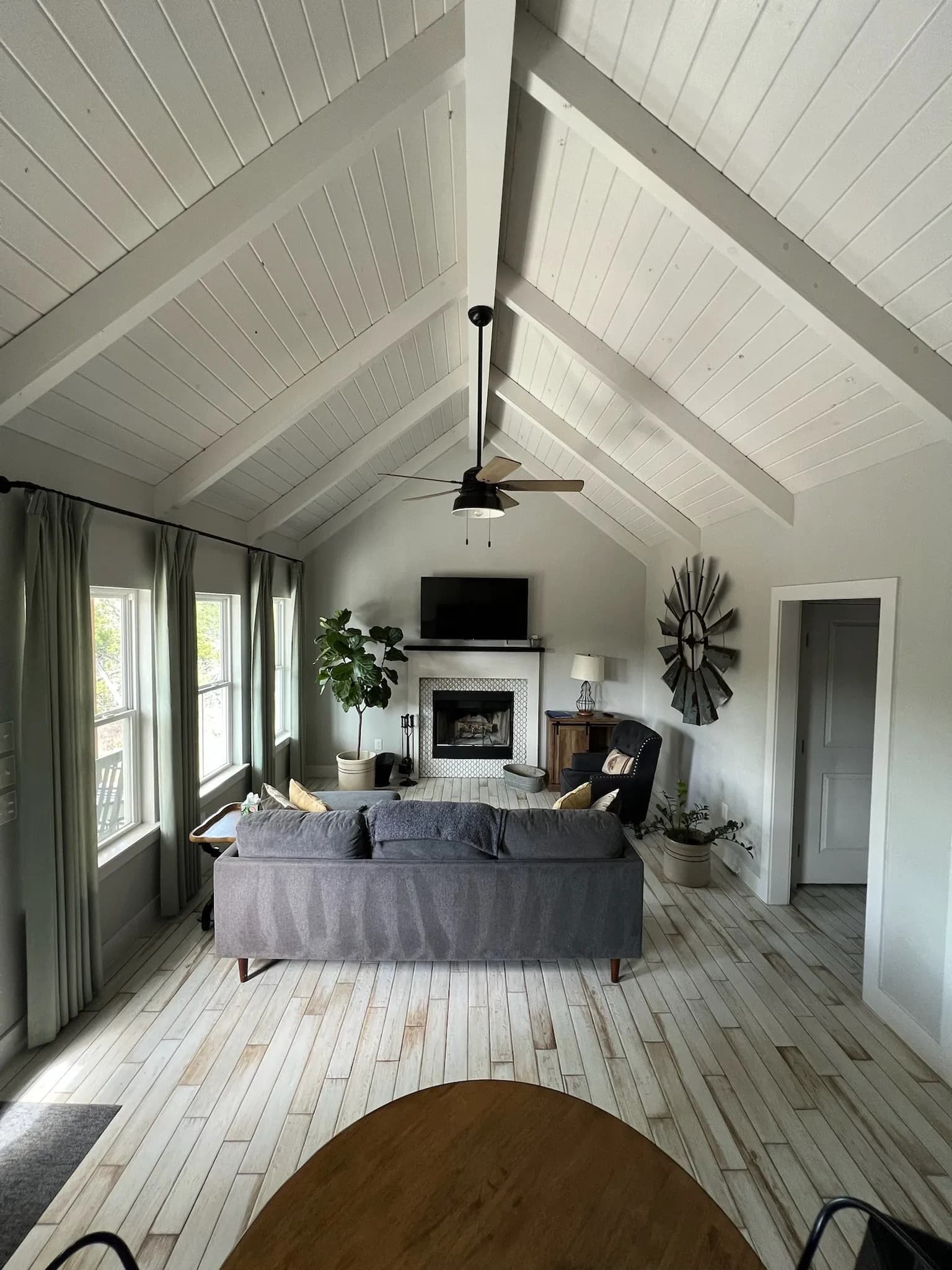 Jackrabbit Cottage living room with vaulted ceiling, gray sofa, and fireplace