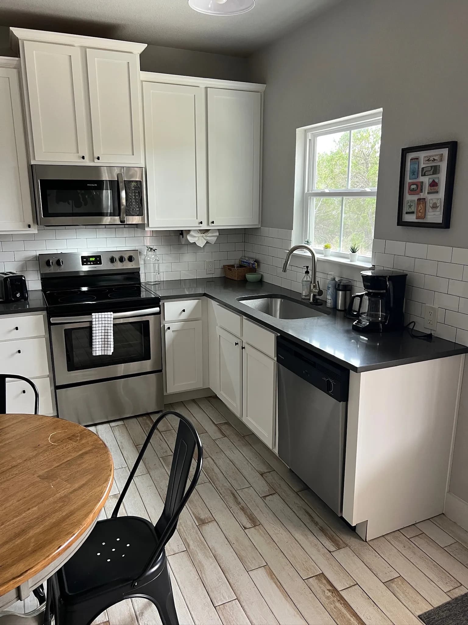 Summermoon Cottage kitchen with stainless appliances and subway tile backsplash
