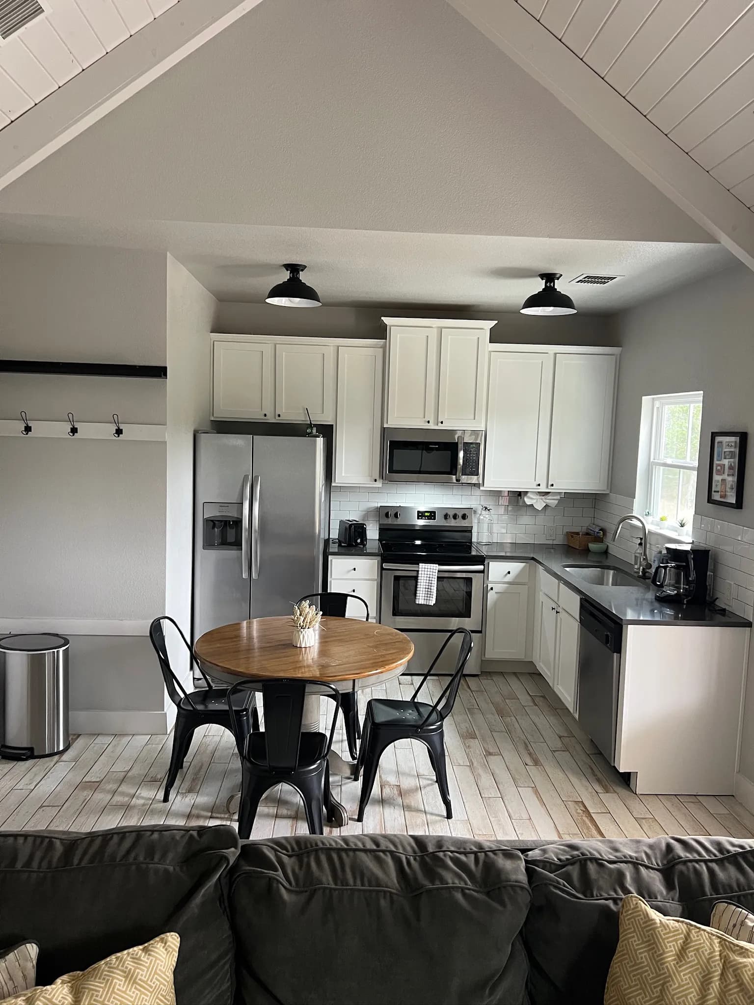 Summermoon Cottage kitchen with white cabinets and round dining table
