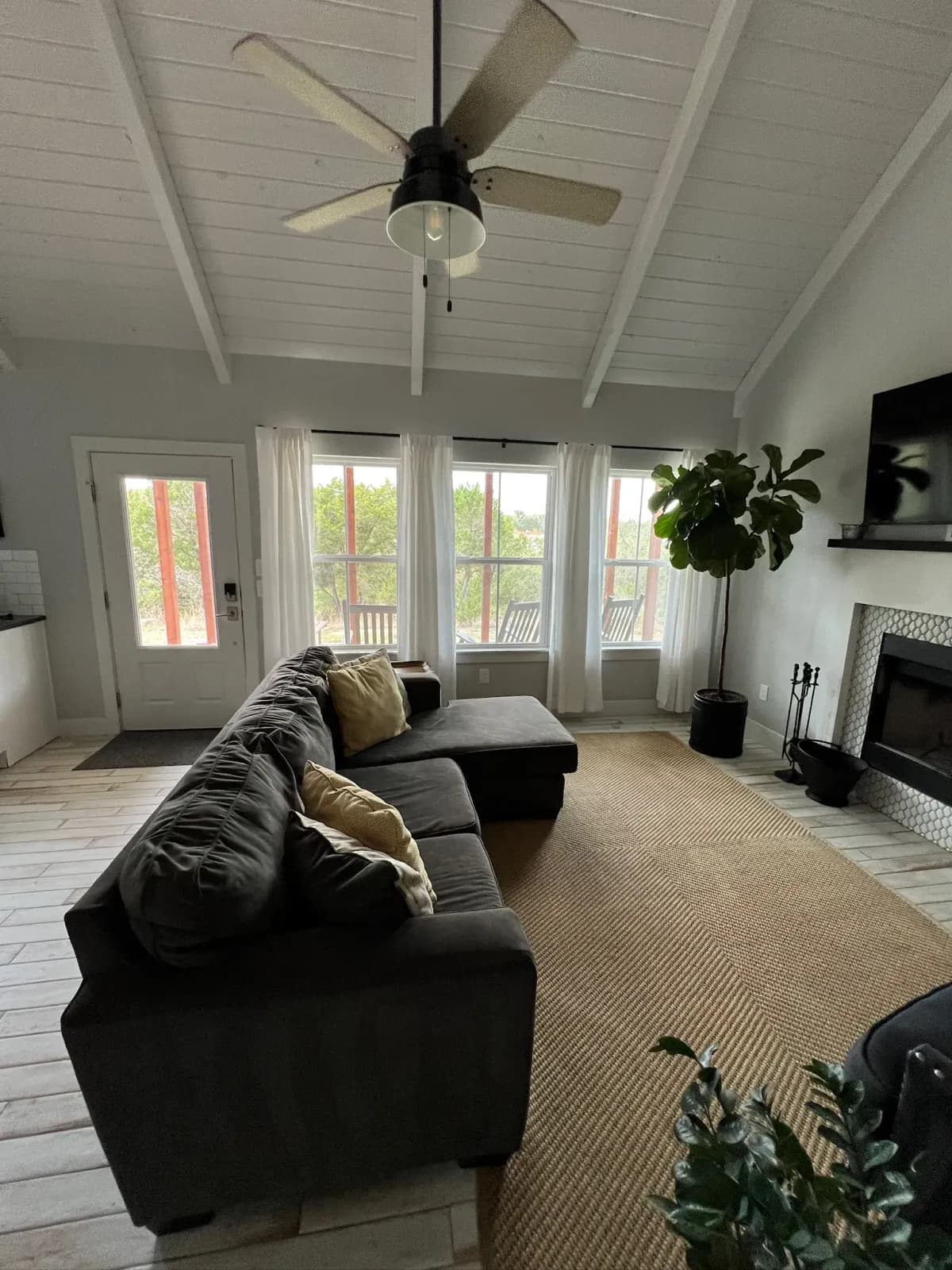 Summermoon Cottage living room with vaulted ceiling, sectional, and fireplace