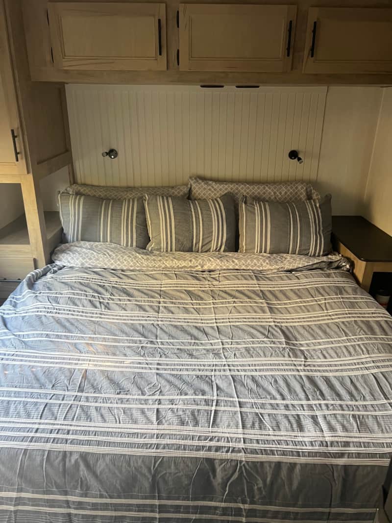 Sleeping area with queen bed inside BlancoBreeze glamping RV