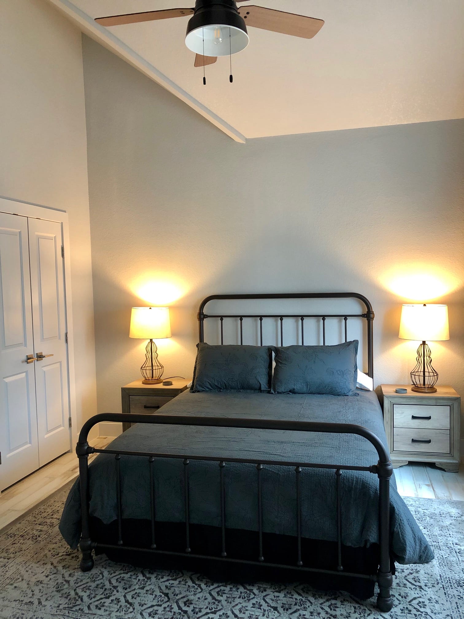 Bedroom with metal bed frame inside Jackrabbit Cottage